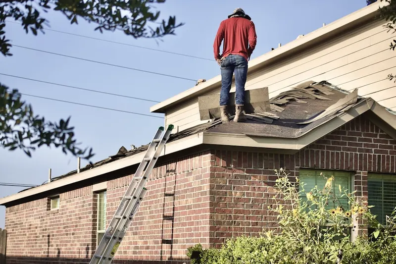 Professional roofer working on a residential roof in Independent Hill